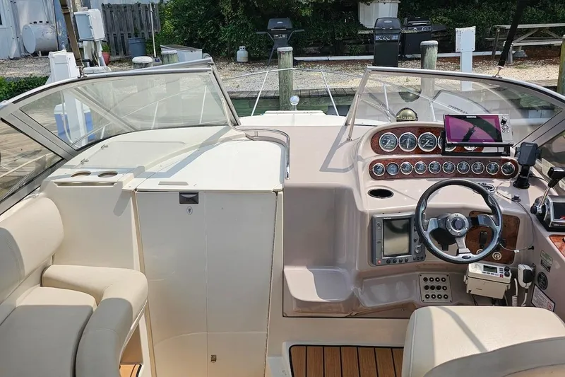 Slide: The Image of 1999 Regal Commodore 292 boat cockpit with steering wheel, gauges, and navigation equipment. - 18