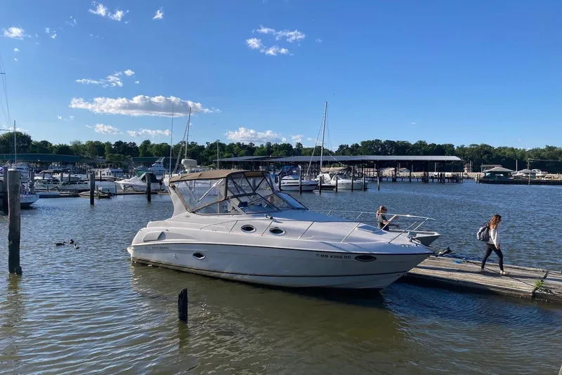 Slide: The Image of 1999 Regal Commodore 292 boat docked at marina under clear blue sky. - 19