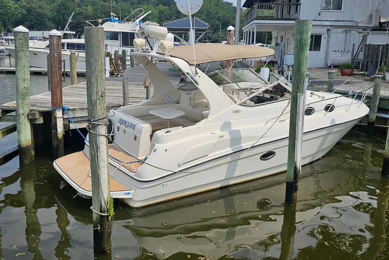 Slide: The Image of 1999 Regal Commodore 292 boat docked at a marina, featuring a sleek design. - 2