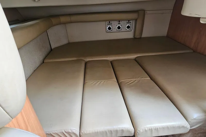 Slide: The Image of 1999 Regal Commodore 292 cabin interior with beige cushioned seating and control panel. - 26