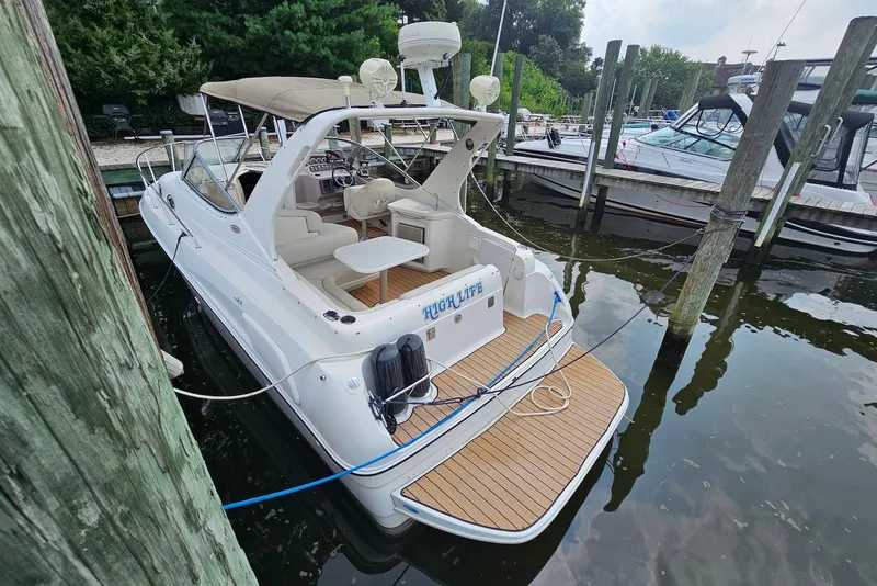 Slide: The Image of 1999 Regal Commodore 292 boat docked at marina, featuring spacious deck and seating area. - 3
