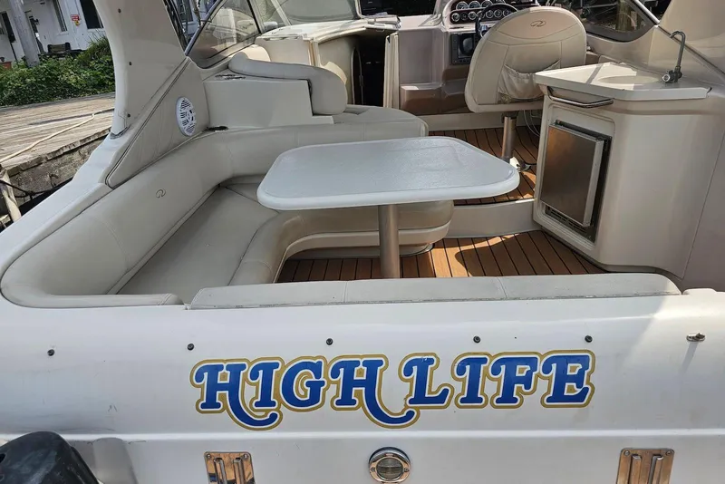 Slide: The Image of 1999 Regal Commodore 292 boat interior with seating, table, and "High Life" text. - 6