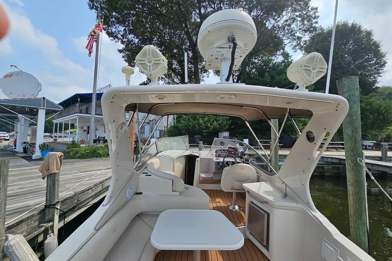 Slide: The Image of 1999 Regal Commodore 292 boat docked, featuring spacious seating and modern amenities. - 9