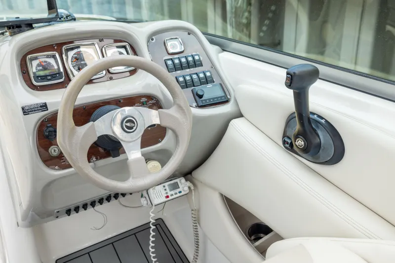 Slide: The Image of 2008 Chaparral 256 SSi boat dashboard with steering wheel and control panel. - 13