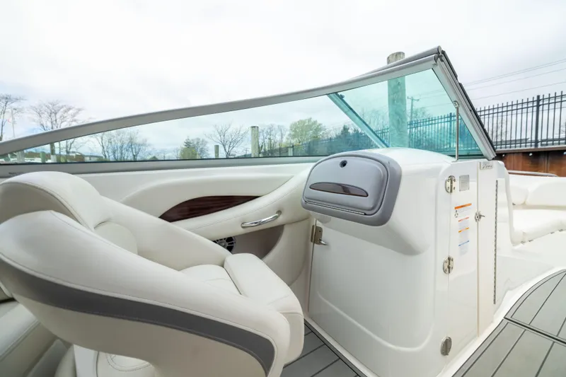 Slide: The Image of 2008 Chaparral 256 SSi boat interior with white seating and sleek dashboard design. - 15