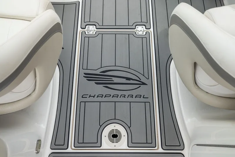 Slide: The Image of 2008 Chaparral 256 SSi boat interior with branded flooring and cushioned seats. - 17