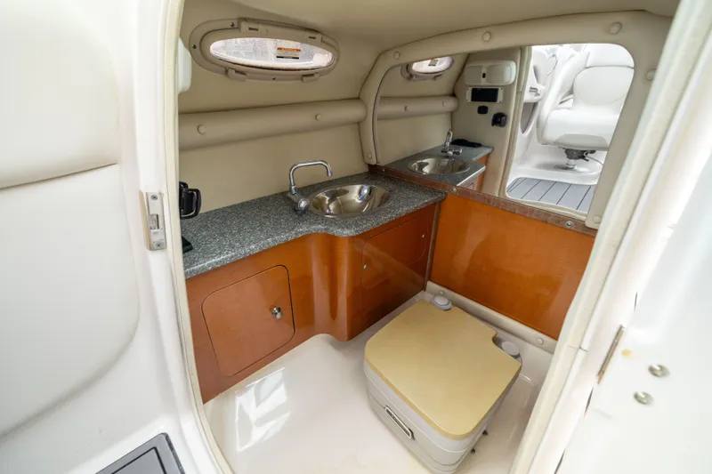 Slide: The Image of 2008 Chaparral 256 SSi boat interior with sink, countertop, and storage. - 18