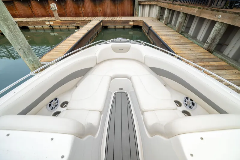 Slide: The Image of 2008 Chaparral 256 SSi boat interior with white seating at dock. - 19