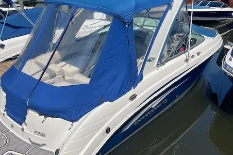 Slide: The Image of 2008 Chaparral 256 SSi boat with blue canopy docked in marina. - 21