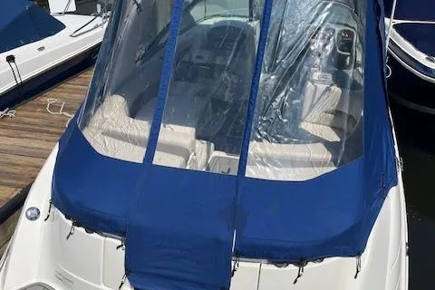 Slide: The Image of 2008 Chaparral 256 SSi boat with blue cover docked at marina. - 22