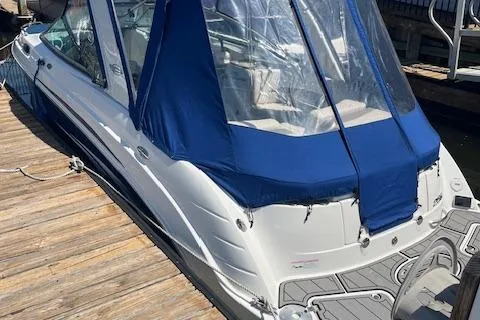 Slide: The Image of 2008 Chaparral 256 SSi boat docked with blue canopy and sleek design. - 23