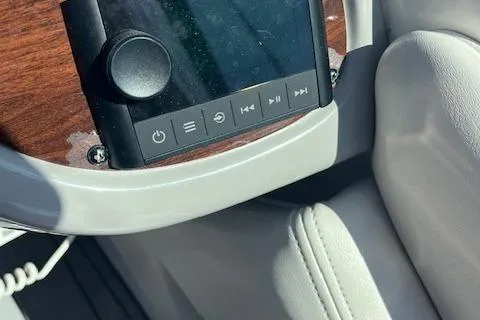 Slide: The Image of 2008 Chaparral 256 SSi boat dashboard with control panel and wood trim. - 6