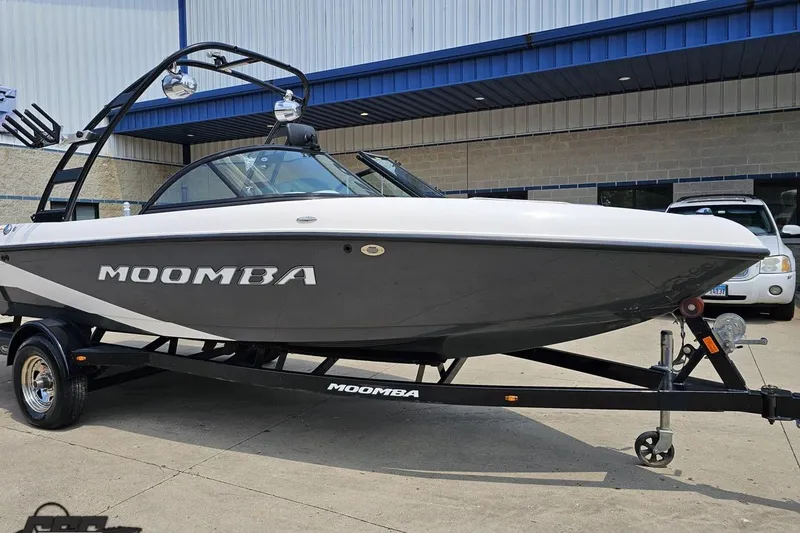 Slide: The Image of 2014 Moomba Outback V boat on trailer, parked outside a building. - 11