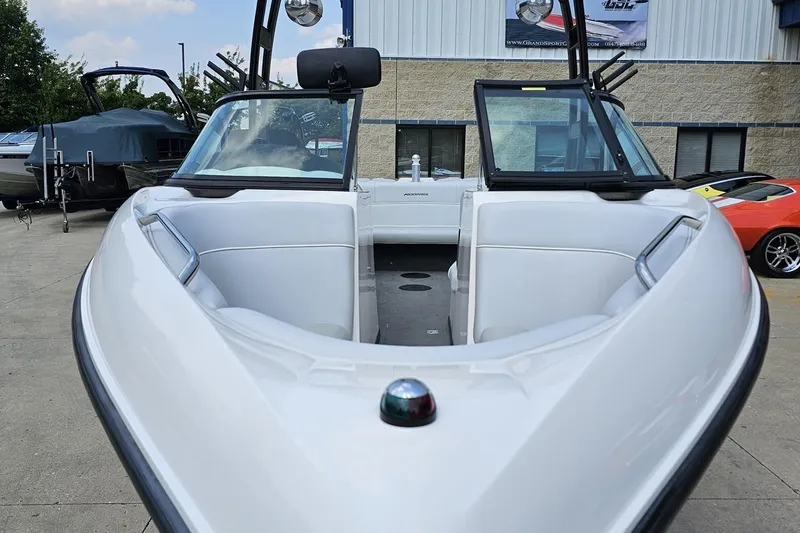Slide: The Image of 2014 Moomba Outback V boat with white interior, parked outdoors. - 14