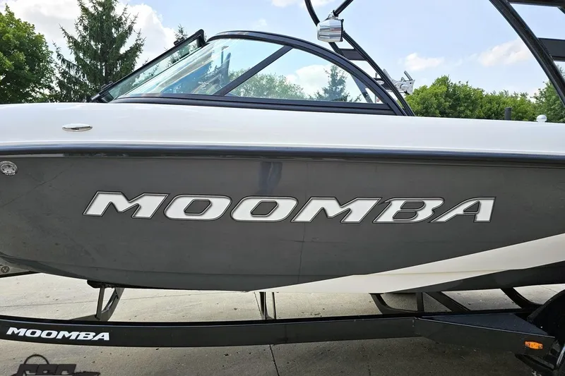 Slide: The Image of 2014 Moomba Outback V boat on trailer, side view with logo visible. - 23