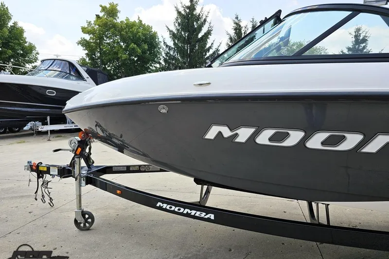 Slide: The Image of 2014 Moomba Outback V boat on trailer, parked outdoors. - 24