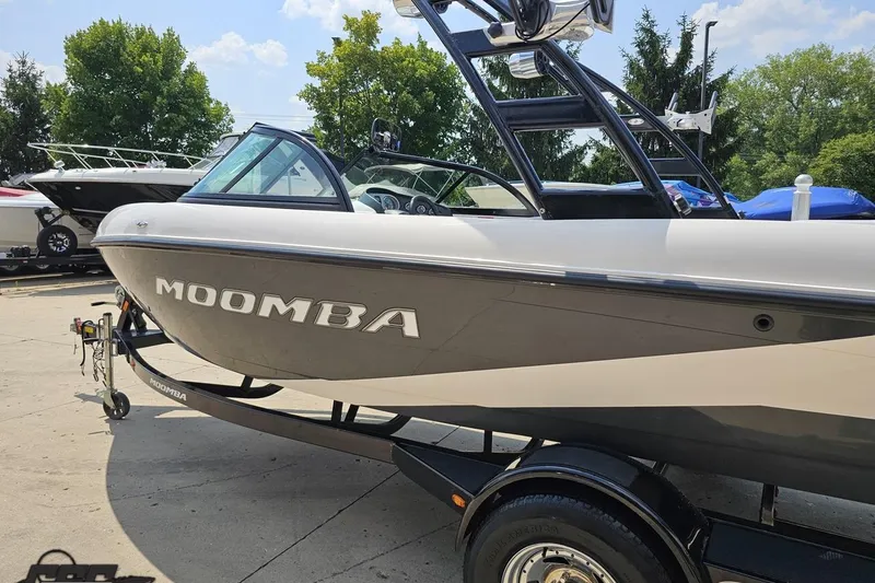 Slide: The Image of 2014 Moomba Outback V boat on trailer, parked outdoors. - 27