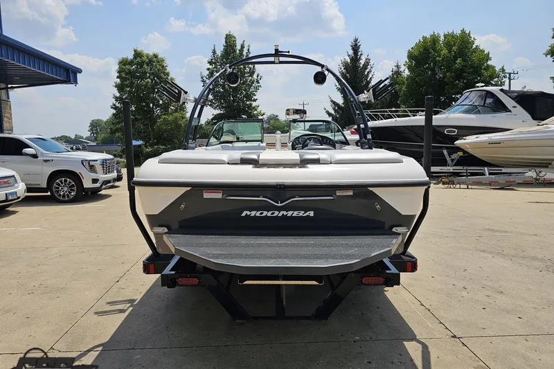 Slide: The Image of 2014 Moomba Outback V boat parked at a marina with other vehicles. - 30