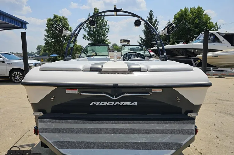 Slide: The Image of 2014 Moomba Outback V boat, rear view, parked outdoors on a sunny day. - 31