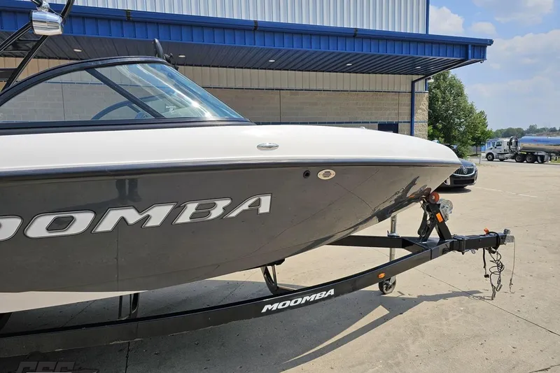 Slide: The Image of 2014 Moomba Outback V boat on trailer outside a building. - 4