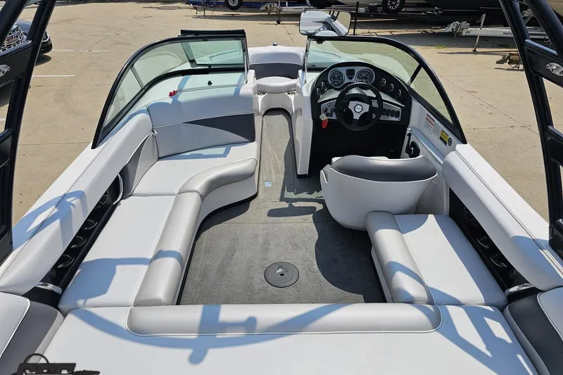 Slide: The Image of 2014 Moomba Outback V boat interior with sleek seating and modern dashboard design. - 44