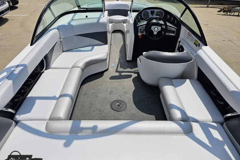 Slide: The Image of 2014 Moomba Outback V boat interior with white seating and steering wheel. - 45