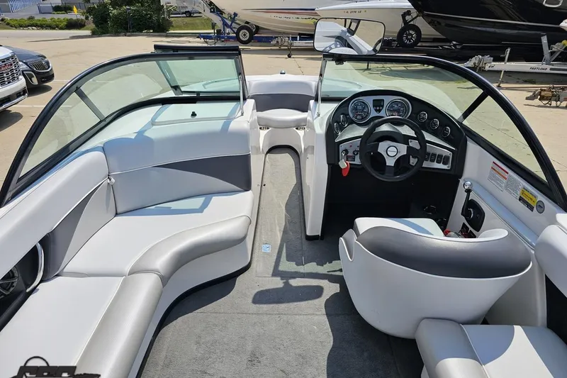 Slide: The Image of 2014 Moomba Outback V boat interior with sleek seating and modern dashboard. - 47