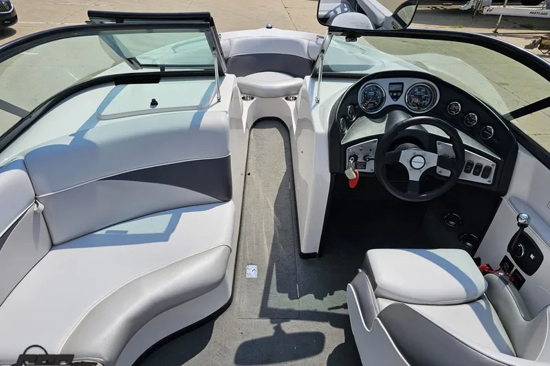 Slide: The Image of 2014 Moomba Outback V boat interior with steering wheel and seating. - 48