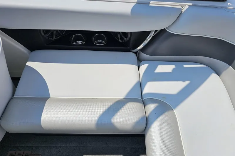 Slide: The Image of 2014 Moomba Outback V interior seating with light gray upholstery and cup holders. - 49