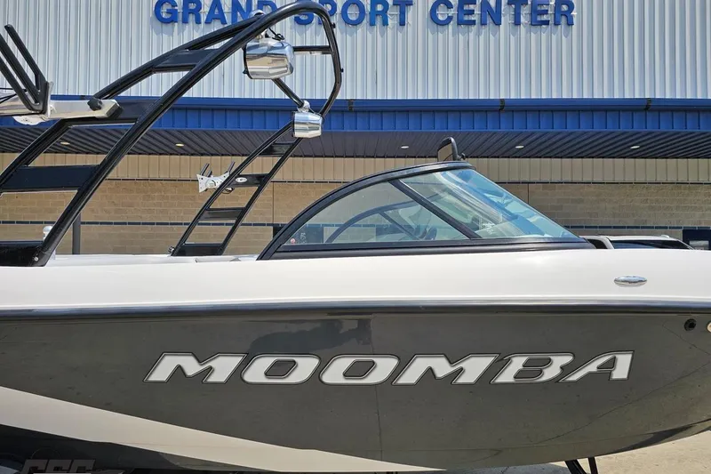 Slide: The Image of 2014 Moomba Outback V boat at Grand Sport Center, featuring sleek design and modern architecture. - 5