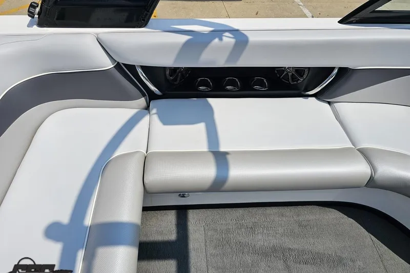 Slide: The Image of 2014 Moomba Outback V interior with white and gray seating, featuring built-in speakers. - 51