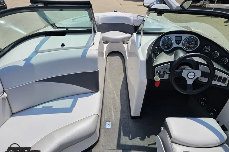 Slide: The Image of 2014 Moomba Outback V boat interior with steering wheel and seating. - 53
