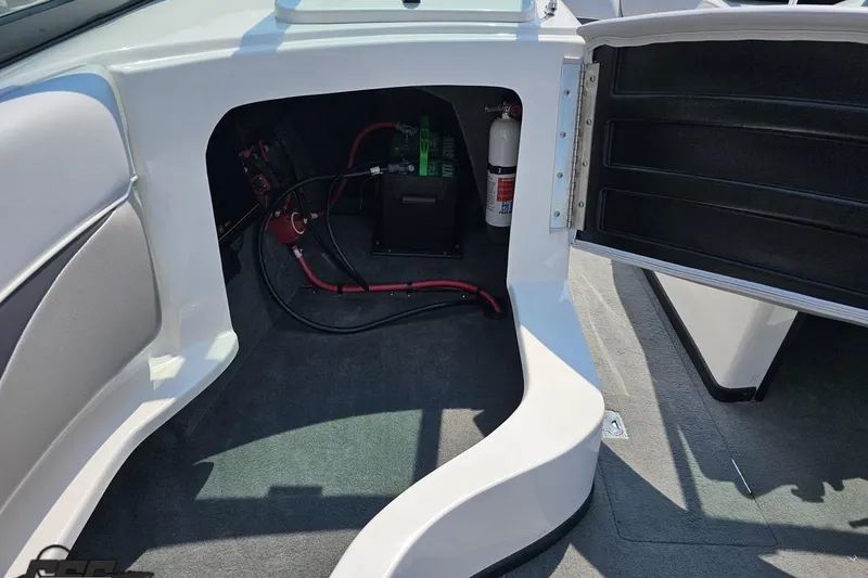 Slide: The Image of 2014 Moomba Outback V interior storage compartment with wiring and fire extinguisher. - 54