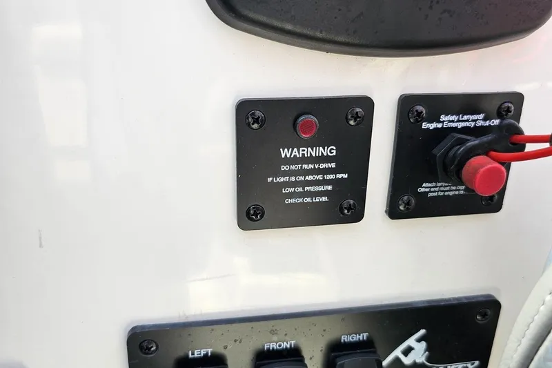 Slide: The Image of 2014 Moomba Outback V dashboard with warning light and safety lanyard. - 59