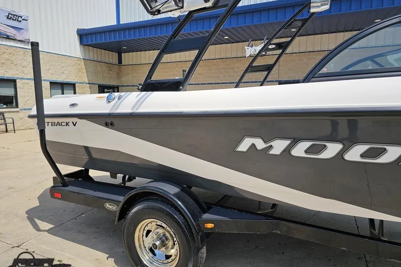 Slide: The Image of 2014 Moomba Outback V boat on trailer, parked outside a building. - 6