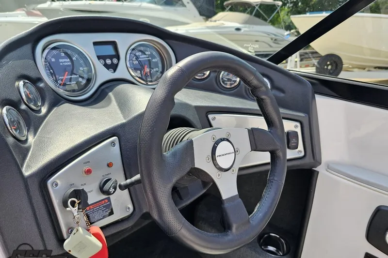 Slide: The Image of 2014 Moomba Outback V dashboard with steering wheel and gauges. - 60