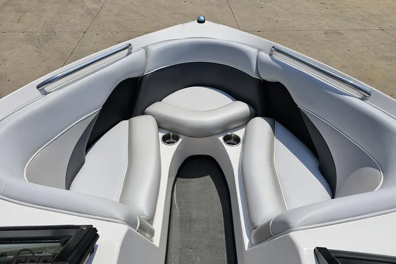 Slide: The Image of 2014 Moomba Outback V boat interior with white cushioned seating and cup holders. - 69