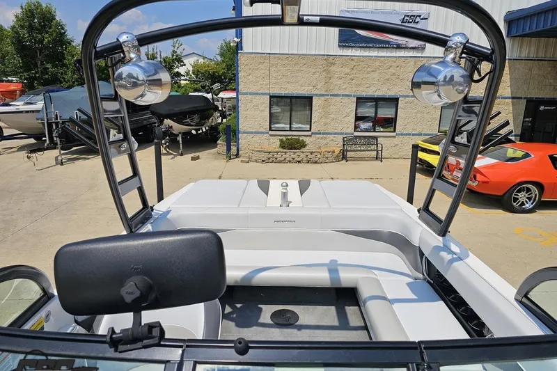 Slide: The Image of 2014 Moomba Outback V boat interior with seating and tower, parked at dealership. - 76