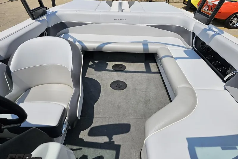 Slide: The Image of 2014 Moomba Outback V boat interior with white seating and gray flooring. - 77