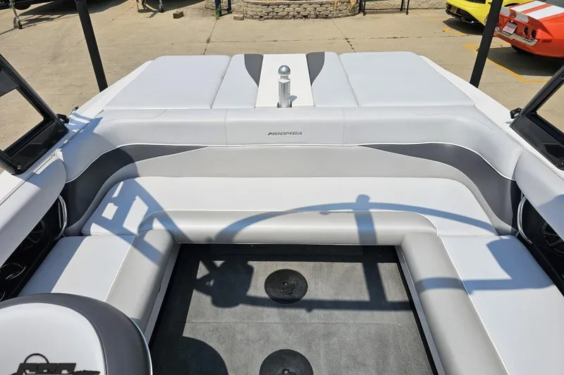 Slide: The Image of 2014 Moomba Outback V boat interior with white and gray seating. - 80