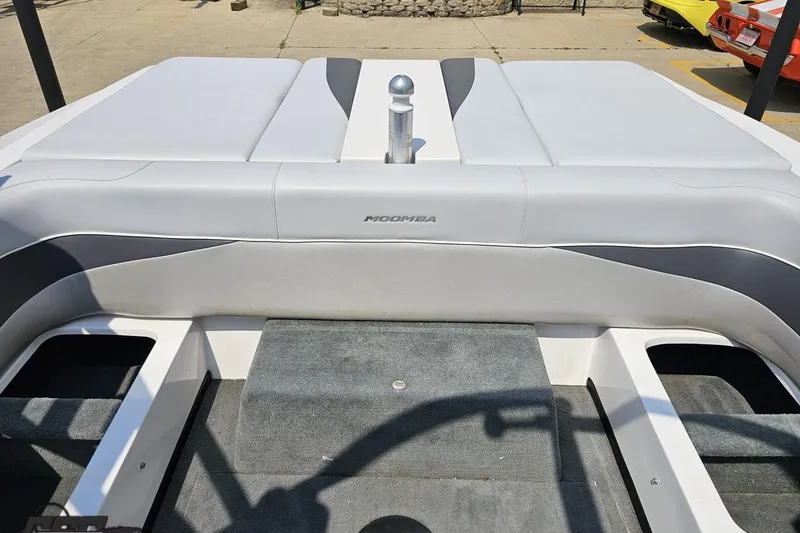 Slide: The Image of 2014 Moomba Outback V boat interior with gray seating and carpeted flooring. - 82