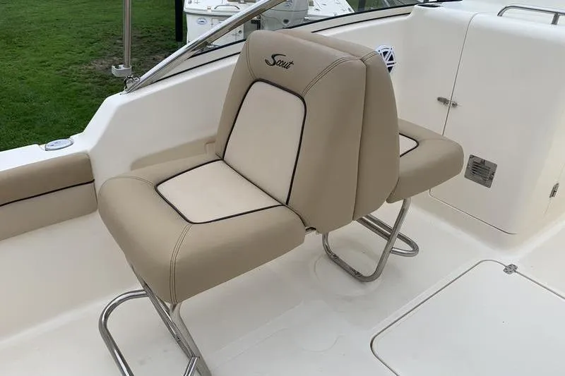 Slide: The Image of 2018 Scout 225 Dorado boat seat with beige upholstery and stainless steel frame. - 11