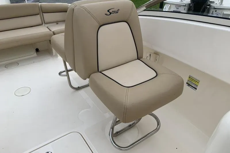 Slide: The Image of 2018 Scout 225 Dorado boat interior with beige seating and stainless steel frame. - 12