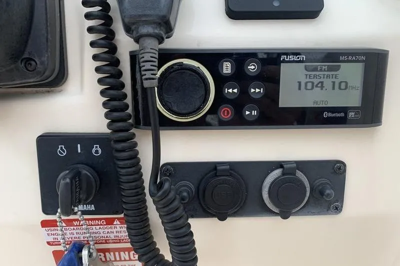 Slide: The Image of Control panel of a 2018 Scout 225 Dorado boat with radio and USB ports. - 20