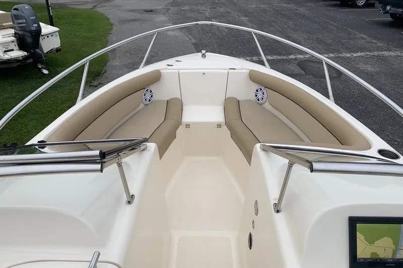 Slide: The Image of 2018 Scout 225 Dorado boat interior with beige seating and stainless steel railings. - 21