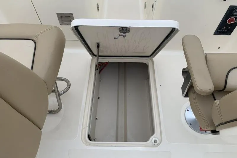 Slide: The Image of Open storage compartment on 2018 Scout 225 Dorado boat with beige seating. - 22
