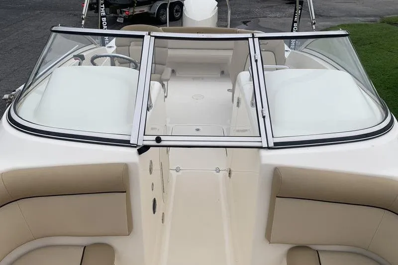 Slide: The Image of 2018 Scout 225 Dorado boat interior with beige seating and windshield. - 23