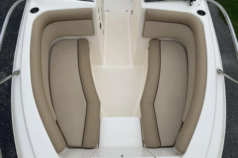 Slide: The Image of 2018 Scout 225 Dorado boat interior with beige cushioned seating. - 25