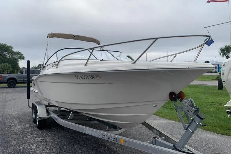 Slide: The Image of 2018 Scout 225 Dorado boat on trailer, parked outdoors. - 6