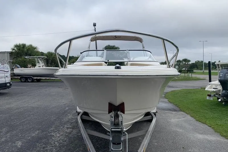 Slide: The Image of 2018 Scout 225 Dorado boat on trailer, parked outdoors on a cloudy day. - 7